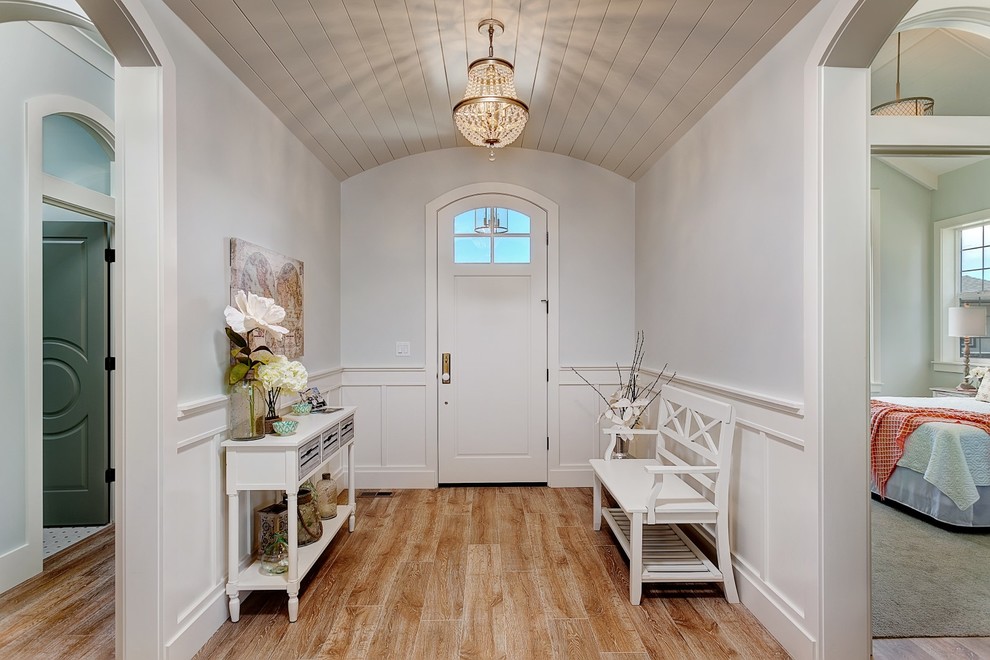 Design ideas for a mid-sized beach style foyer in Boise with blue walls, medium hardwood floors, a single front door and a white front door.