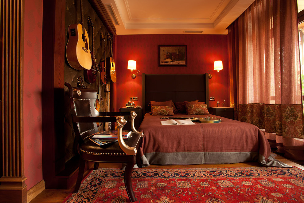Photo of a mid-sized transitional master bedroom in Moscow with red walls, medium hardwood floors and orange floor.