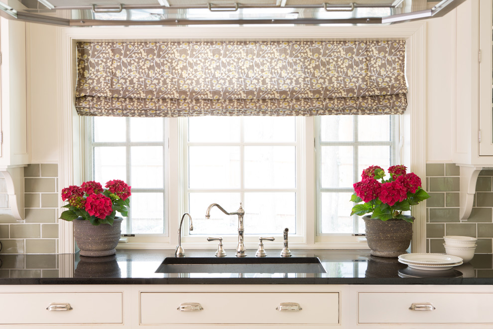 Inspiration for a transitional eat-in kitchen remodel in DC Metro with a drop-in sink, flat-panel cabinets, white cabinets, granite countertops, beige backsplash, subway tile backsplash and stainless steel appliances