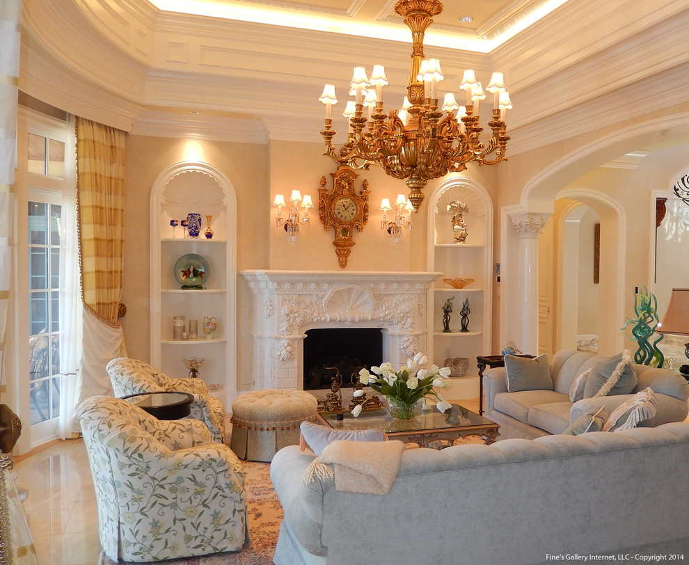 This is an example of a large mediterranean living room in Miami with beige walls, marble floors, a two-sided fireplace and a stone fireplace surround.
