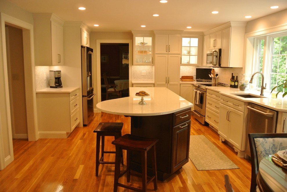 Example of a transitional medium tone wood floor eat-in kitchen design in Boston with an undermount sink, shaker cabinets, quartz countertops, beige backsplash, mosaic tile backsplash, stainless steel appliances, an island and white countertops