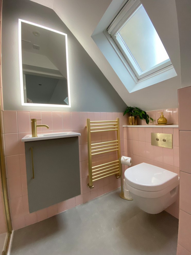Design ideas for a medium sized contemporary grey and pink ensuite half tiled bathroom in Other with flat-panel cabinets, grey cabinets, a wall mounted toilet, pink tiles, ceramic tiles, grey walls, laminate floors, an integrated sink, quartz worktops, grey floors, white worktops, a built in vanity unit, a walk-in shower, a hinged door and a single sink.