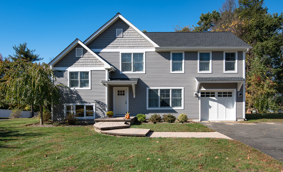 Inspiration for a mid-sized transitional gray two-story vinyl gable roof remodel in New York with a shingle roof