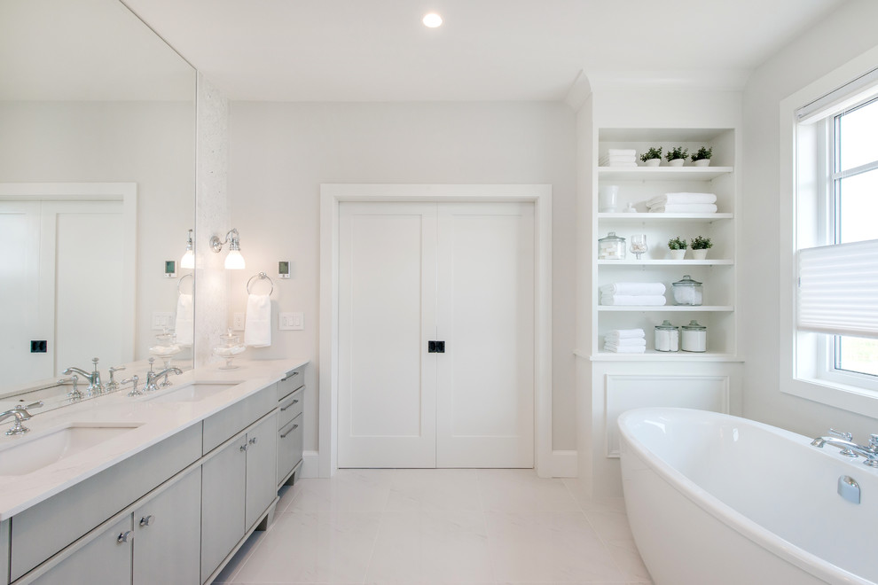 Large transitional master multicolored tile and ceramic tile ceramic tile freestanding bathtub photo in Calgary with an undermount sink, flat-panel cabinets, gray cabinets, quartz countertops and white walls