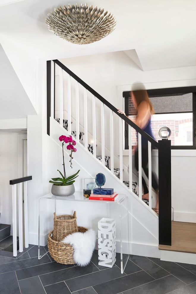 Home design - mid-sized transitional slate floor home design idea in Toronto with white walls and a medium wood front door