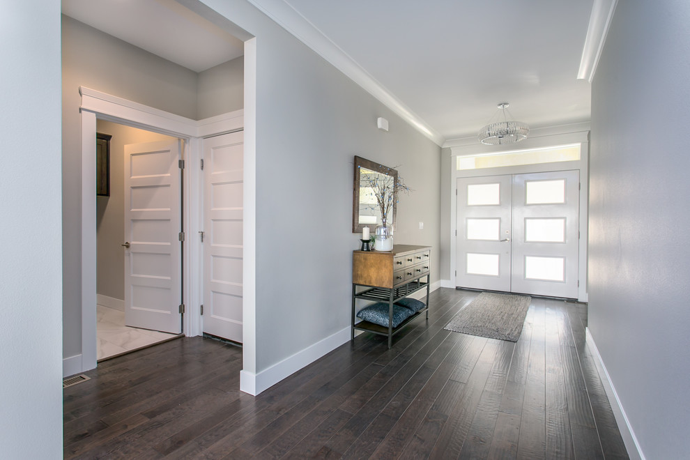 Large transitional foyer in Seattle with grey walls, dark hardwood floors, a double front door and a white front door.