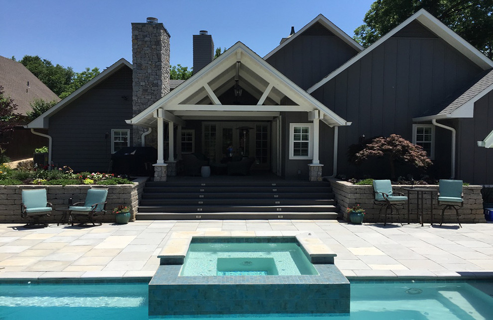 Large transitional backyard concrete paver and rectangular hot tub photo