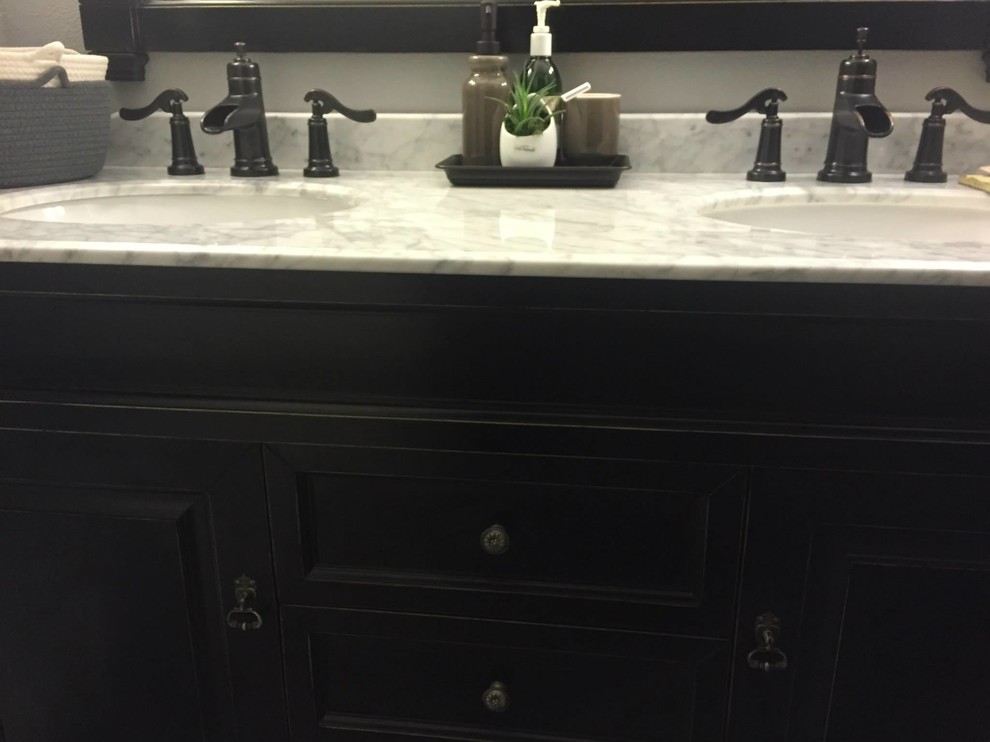 Example of a transitional bathroom design in Phoenix with marble countertops