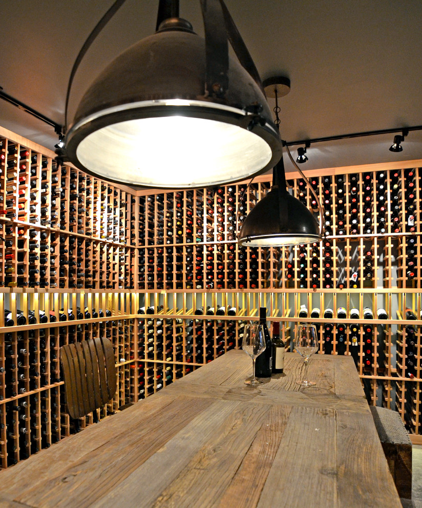 This is an example of a large industrial wine cellar in Seattle with concrete floors and storage racks.
