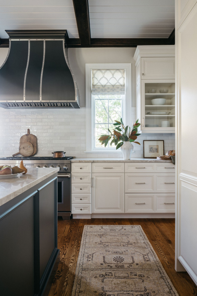 Inspiration for a mid-sized medium tone wood floor, brown floor and exposed beam eat-in kitchen remodel in Chicago with recessed-panel cabinets, white cabinets, quartzite countertops, white backsplash, subway tile backsplash, stainless steel appliances, an island and white countertops