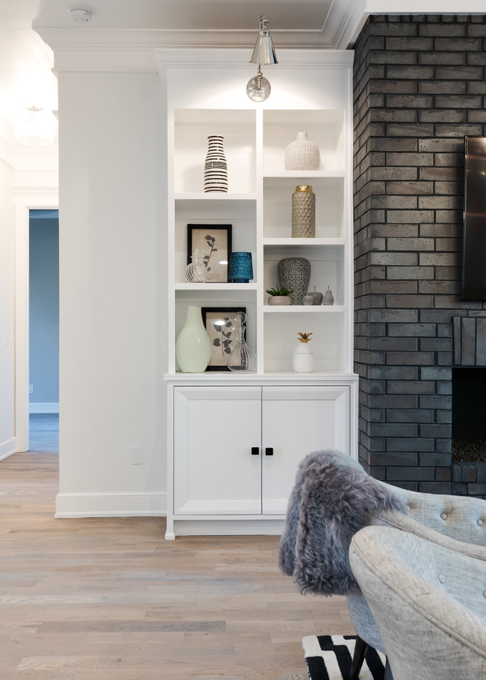 Inspiration for an expansive transitional formal open concept living room in Oklahoma City with white walls, medium hardwood floors, a standard fireplace, a brick fireplace surround and a wall-mounted tv.