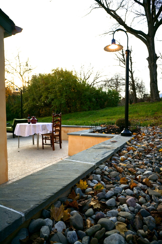 This is an example of a mid-sized mediterranean backyard patio in Philadelphia with an outdoor kitchen.
