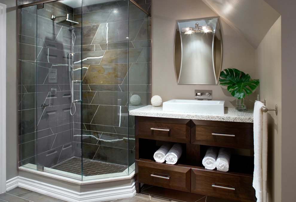 This is an example of a mid-sized modern 3/4 bathroom in Toronto with flat-panel cabinets, dark wood cabinets, terrazzo benchtops, a corner shower, gray tile, stone tile, beige walls, porcelain floors and a vessel sink.