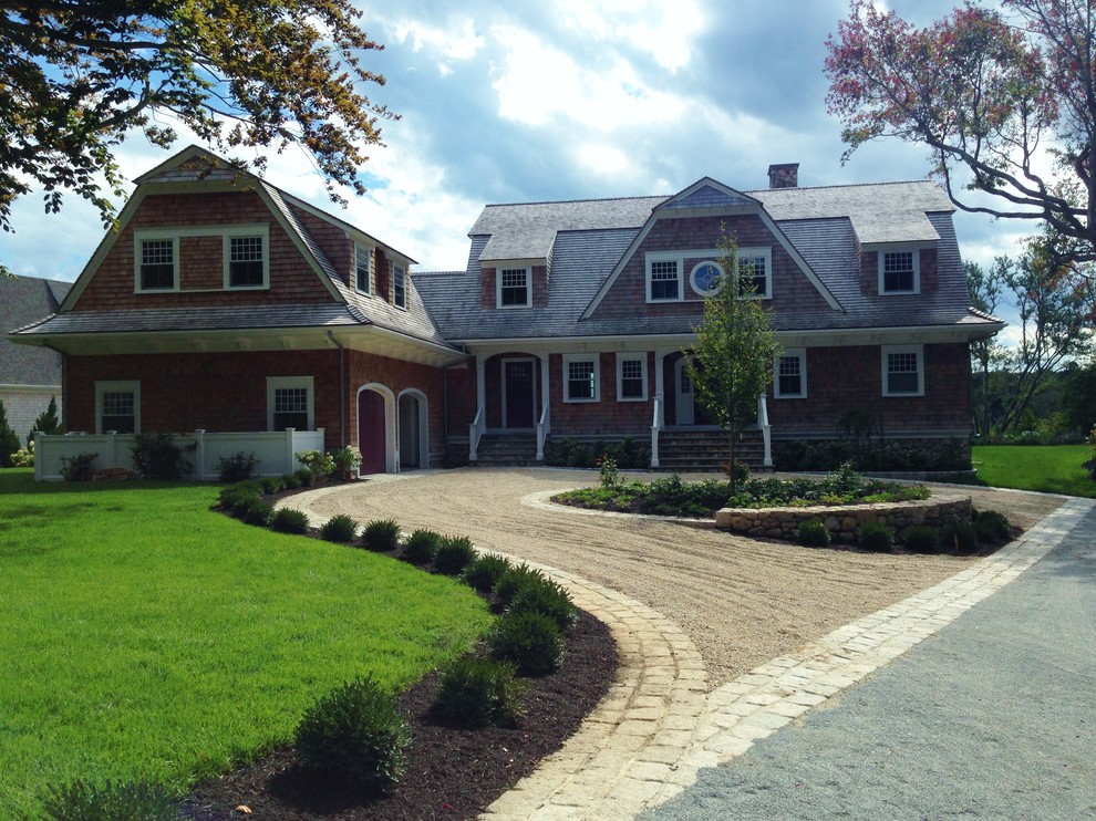 Inspiration for a large country front yard partial sun driveway for summer in Boston with a retaining wall and gravel.