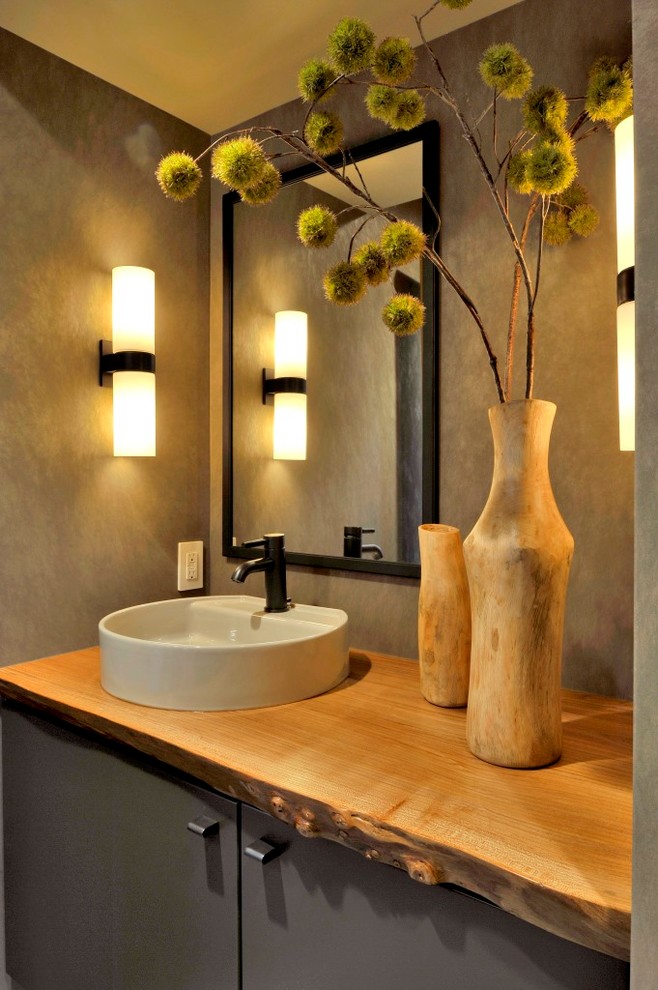 Design ideas for a small contemporary powder room in Seattle with flat-panel cabinets, grey cabinets, a one-piece toilet, grey walls, a pedestal sink, wood benchtops and brown benchtops.