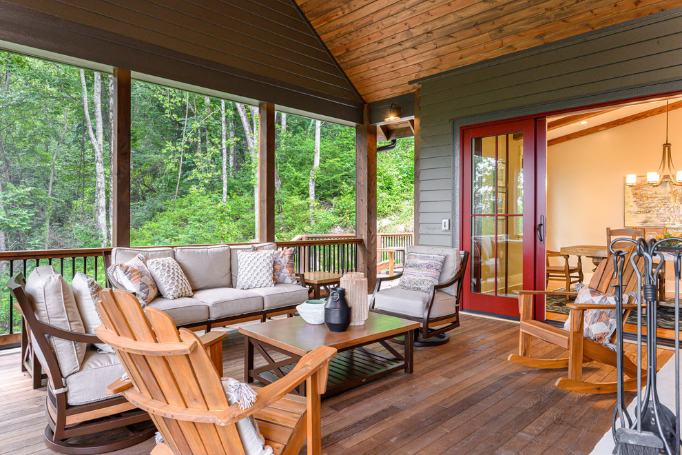 Inspiration for a rustic deck remodel with a roof extension