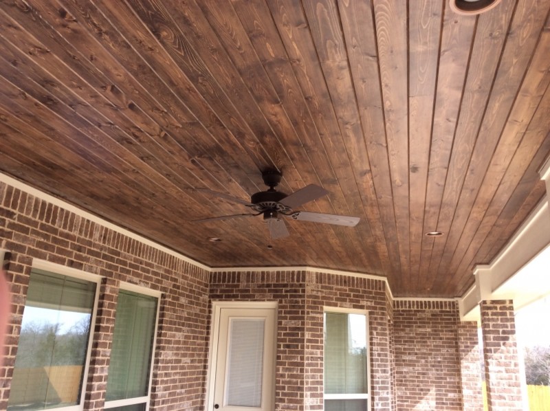 Deck - mid-sized rustic backyard deck idea in Austin with a roof extension