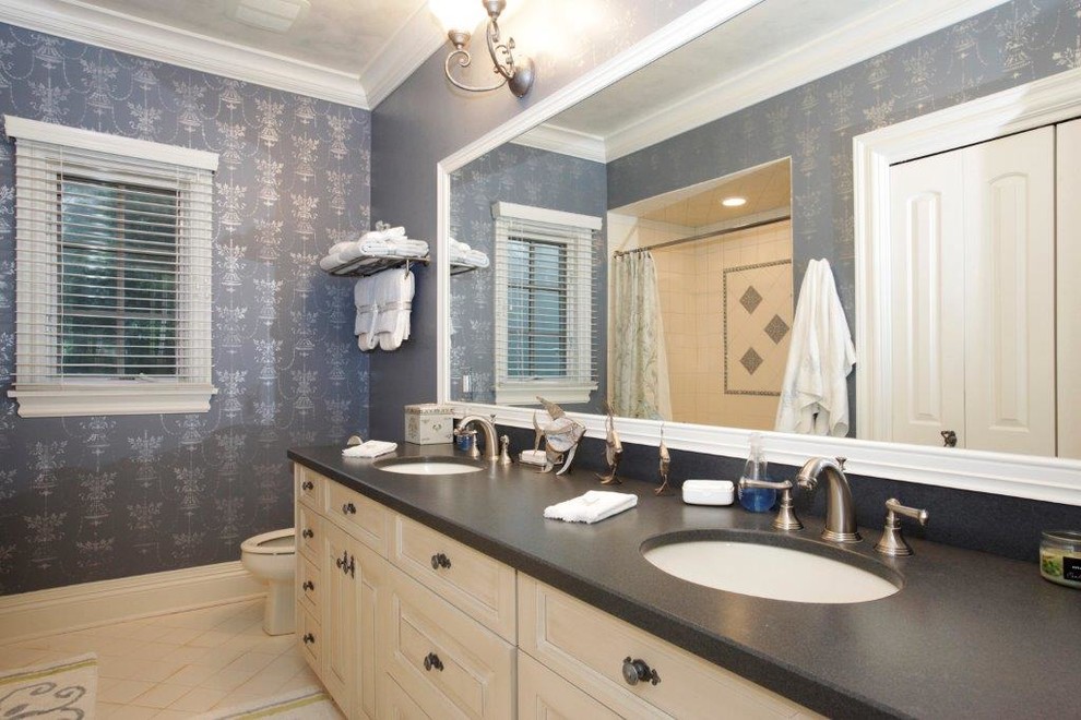This is an example of a mid-sized traditional kids bathroom in New York with raised-panel cabinets, white cabinets, blue tile, glass sheet wall and marble benchtops.
