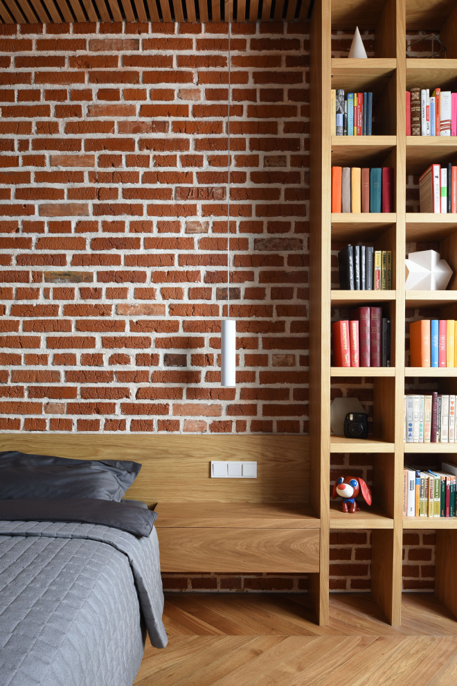 This is an example of an industrial bedroom with red walls.