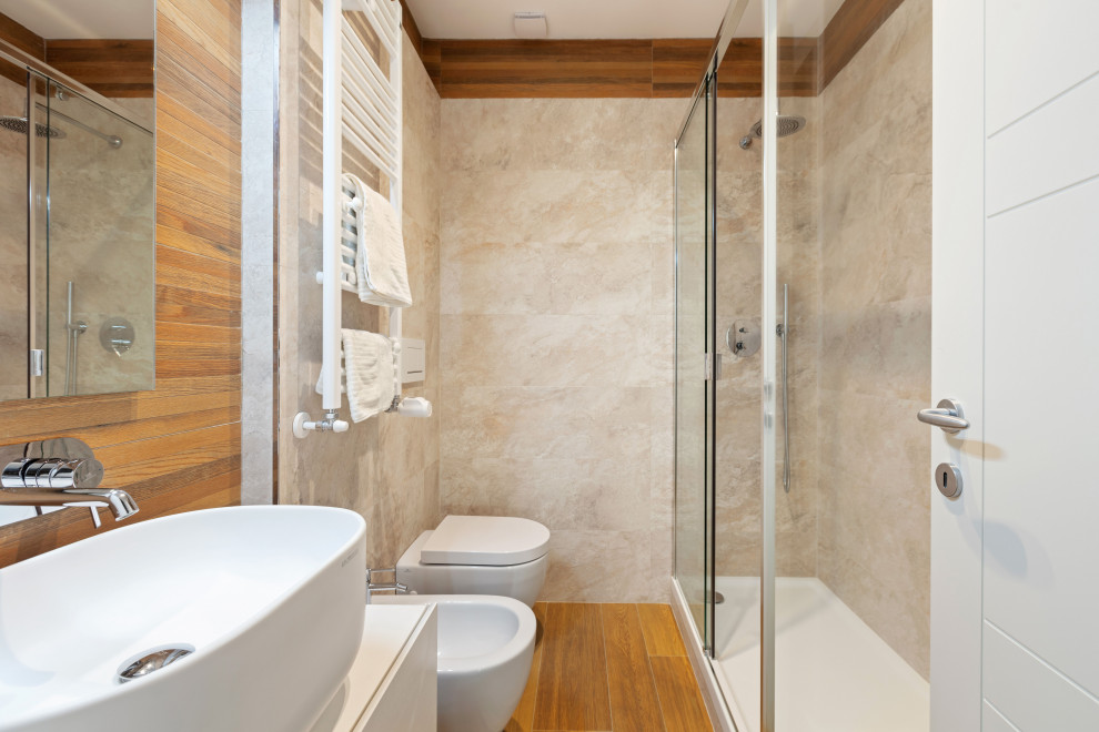 Photo of a mid-sized contemporary 3/4 bathroom in Rome with white cabinets, a corner shower, a wall-mount toilet, porcelain tile, porcelain floors, a vessel sink, brown floor, a sliding shower screen, white benchtops, flat-panel cabinets and beige tile.