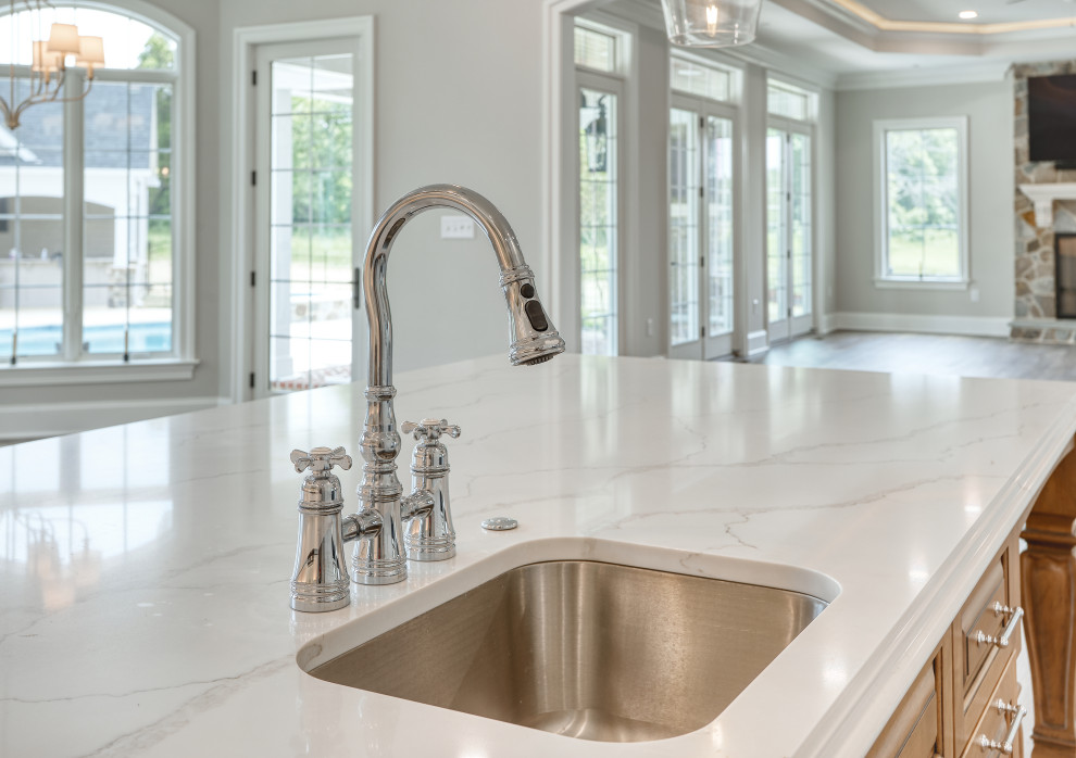 Transitional Kitchen with Two Toned Gathering Island & Archways