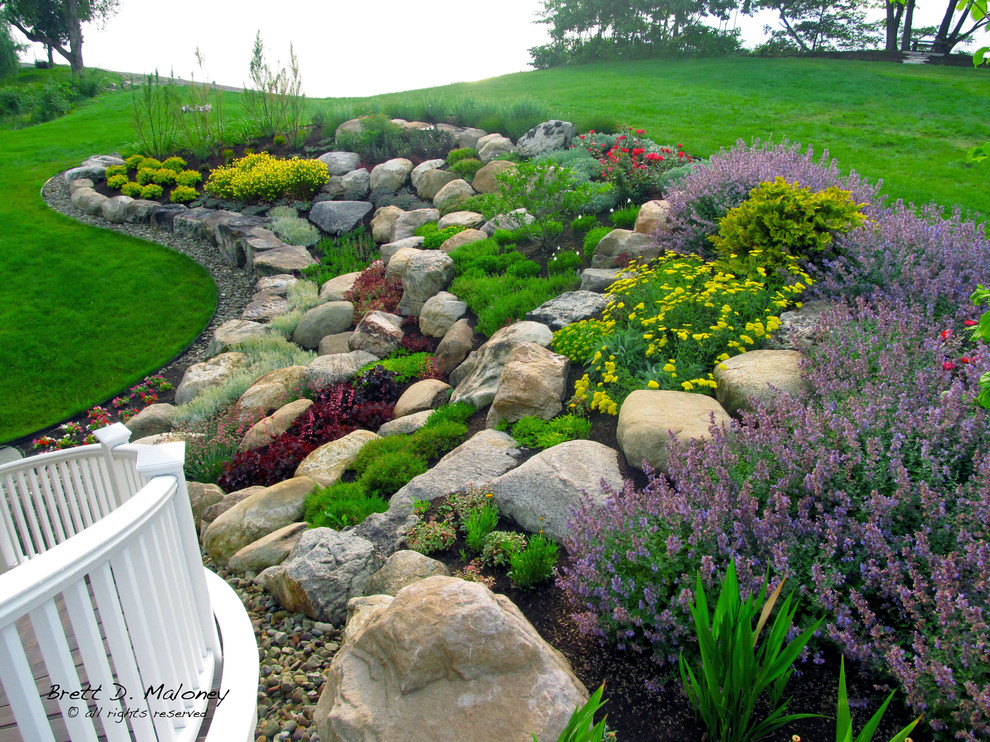 This is an example of a large beach style sloped full sun xeriscape for summer in Other.