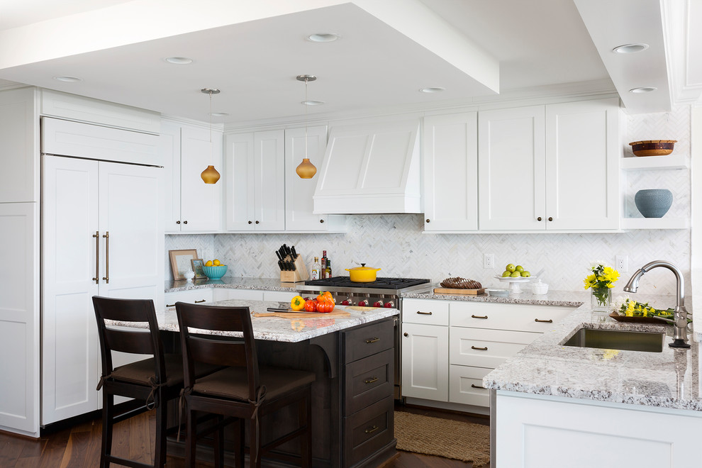 Design ideas for a traditional u-shaped kitchen in DC Metro with an undermount sink, shaker cabinets, white cabinets, white splashback, panelled appliances, dark hardwood floors, with island and brown floor.