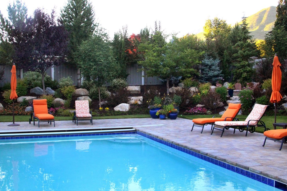 Traditional backyard rectangular pool in Salt Lake City with with a pool and stamped concrete.