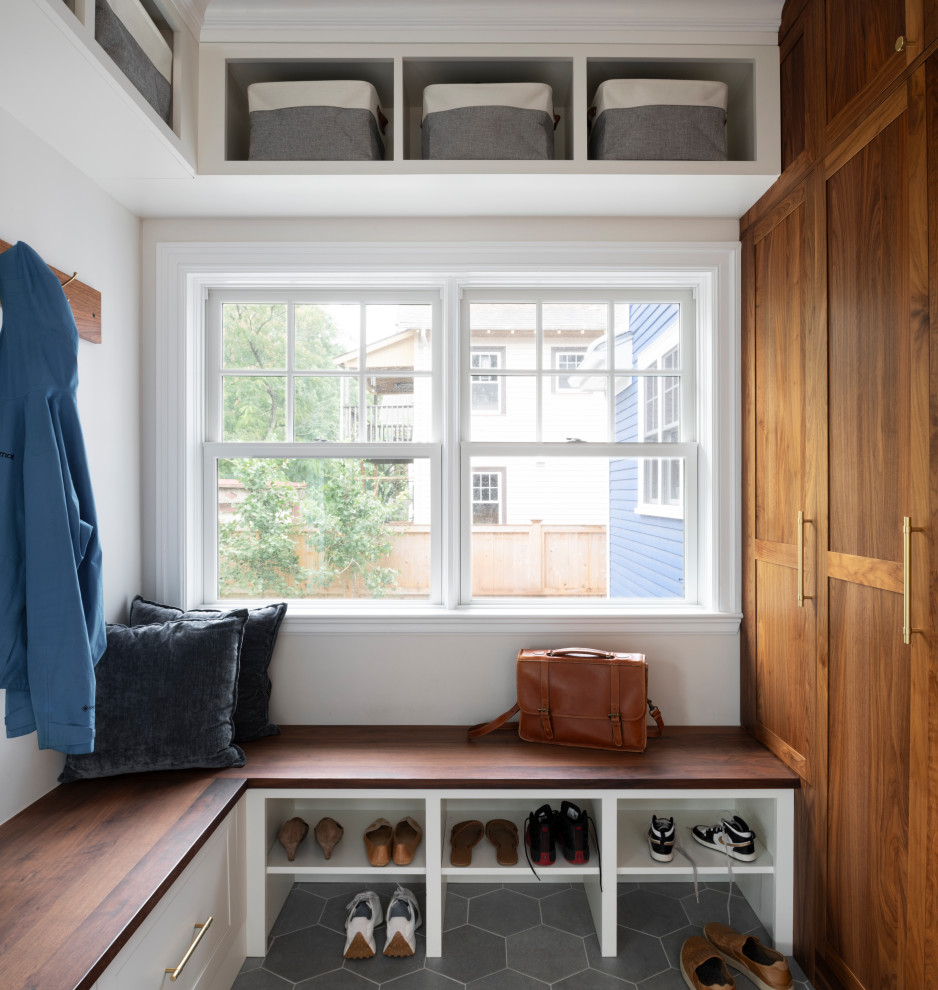 Inspiration for a transitional mudroom remodel in Boston with white walls