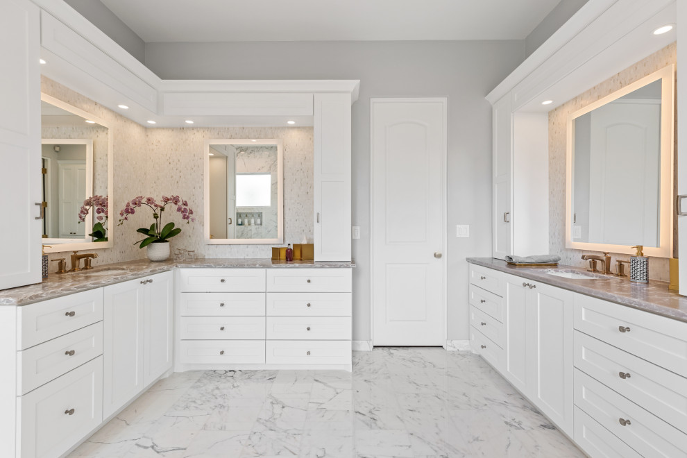 This is an example of a large traditional master wet room bathroom in Dallas with shaker cabinets, white cabinets, a freestanding tub, a one-piece toilet, white tile, marble, grey walls, marble floors, an undermount sink, engineered quartz benchtops, white floor, a hinged shower door, beige benchtops, a single vanity, a built-in vanity and coffered.