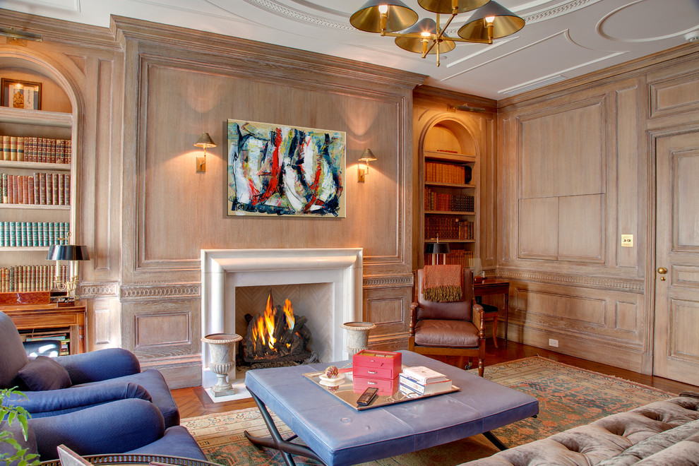 Photo of a traditional enclosed family room in New York with a library, brown walls, dark hardwood floors, a standard fireplace, a tile fireplace surround and no tv.