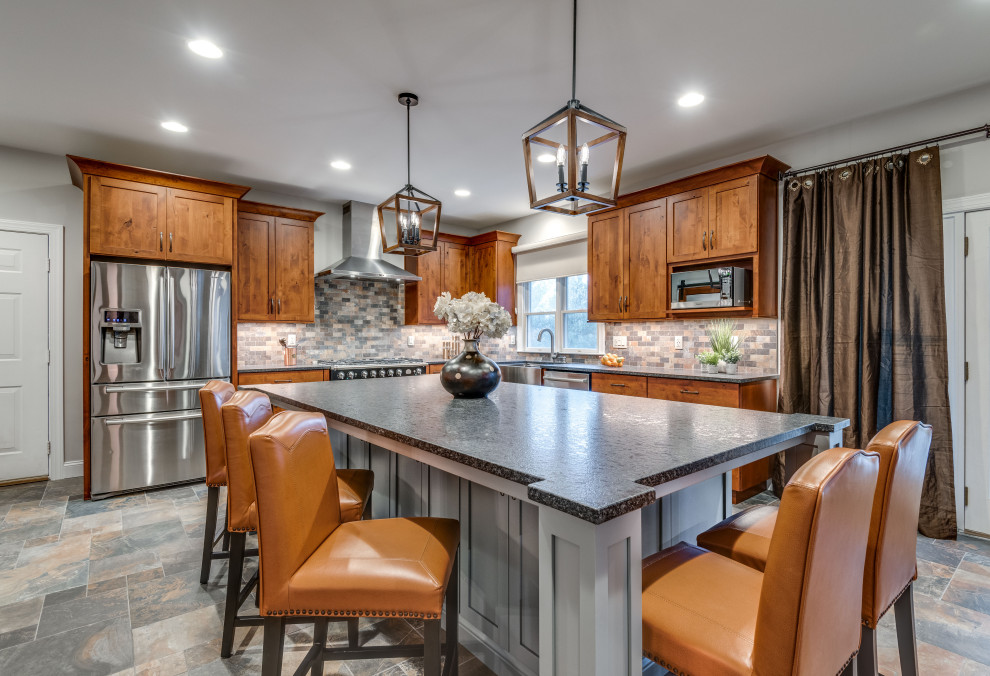 Expansive country u-shaped kitchen in DC Metro with a farmhouse sink, shaker cabinets, granite benchtops and with island.