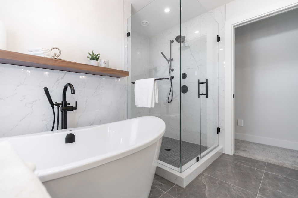 Large trendy master white tile and porcelain tile porcelain tile, gray floor and double-sink bathroom photo in Vancouver with a wall-mount toilet, white walls, a drop-in sink, quartzite countertops, a hinged shower door and white countertops