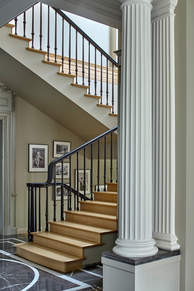 Photo of a transitional wood staircase in Saint Petersburg with wood risers and metal railing.