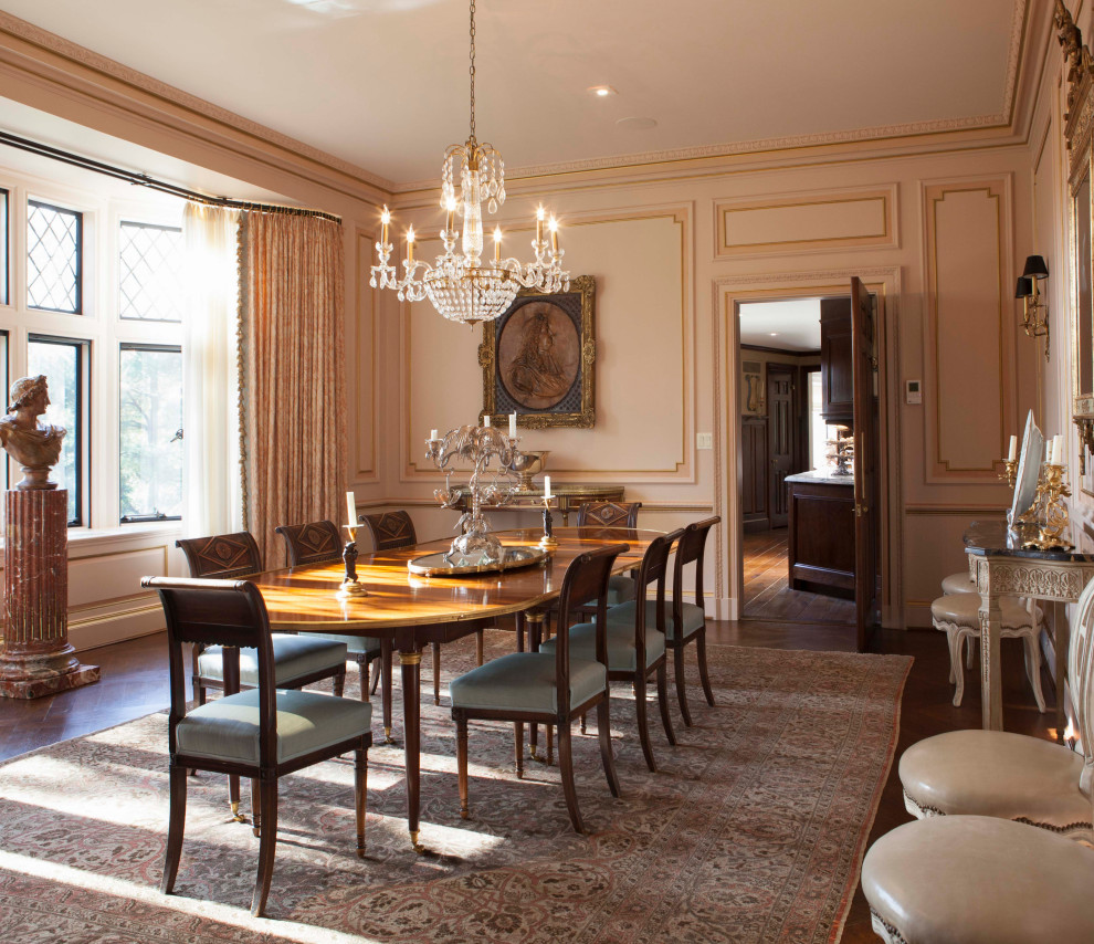 Photo of a traditional separate dining room in New York with beige walls, dark hardwood floors and brown floor.