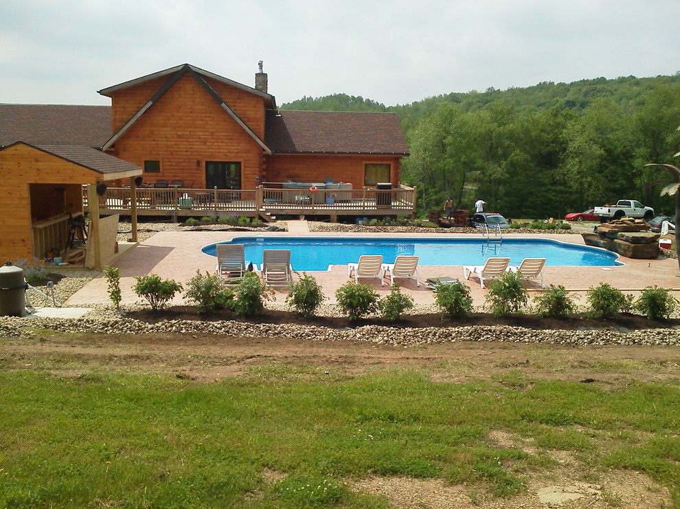 Inspiration for a backyard brick and custom-shaped pool remodel