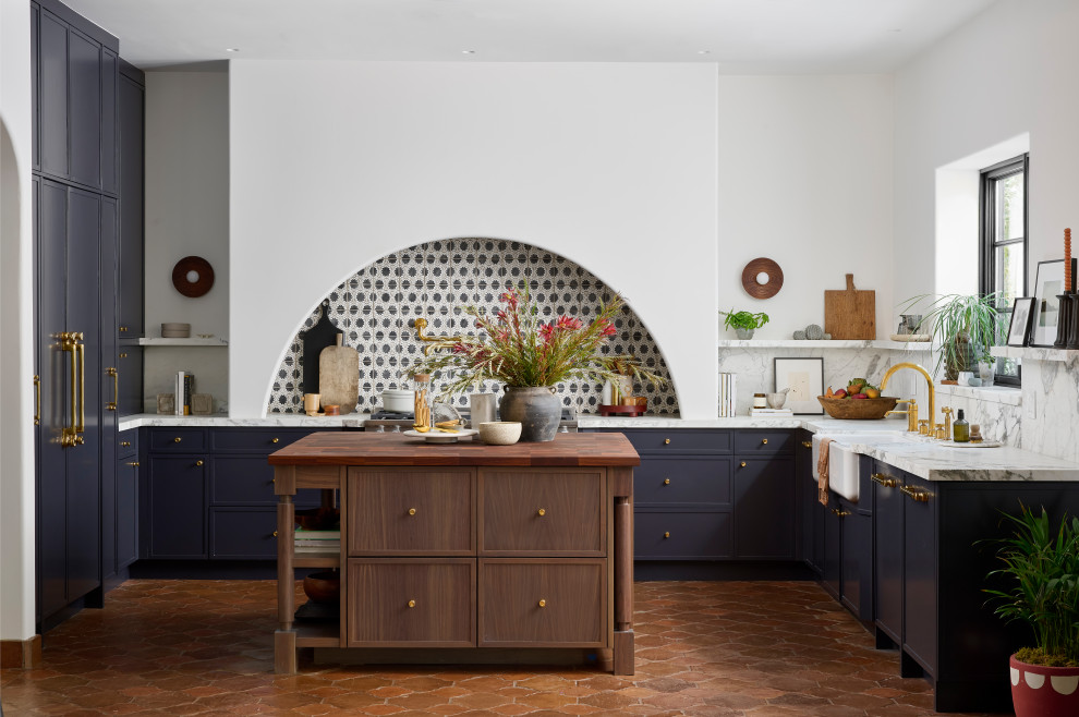 Photo of an open plan kitchen in Phoenix with a farmhouse sink, shaker cabinets, grey cabinets, marble benchtops, multi-coloured splashback, marble splashback, panelled appliances, with island, brown floor and multi-coloured benchtop.