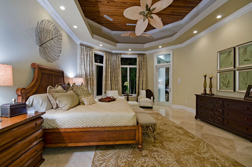 Inspiration for an expansive beach style master bedroom in Miami with beige walls, marble floors and no fireplace.