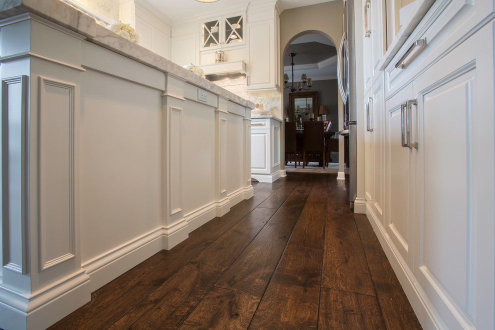 Inspiration for a mid-sized transitional u-shaped dark wood floor eat-in kitchen remodel in Chicago with white cabinets, multicolored backsplash, stainless steel appliances and an island