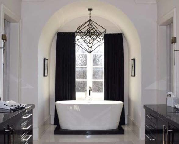 This is an example of a large traditional master bathroom in Atlanta with a freestanding tub, white walls, an undermount sink, marble benchtops, flat-panel cabinets and black cabinets.