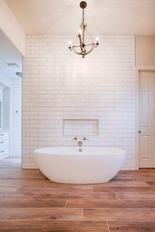 Freestanding bathtub - huge transitional master brown tile and porcelain tile porcelain tile freestanding bathtub idea in Phoenix with shaker cabinets, white cabinets, a two-piece toilet, gray walls, an undermount sink and quartzite countertops