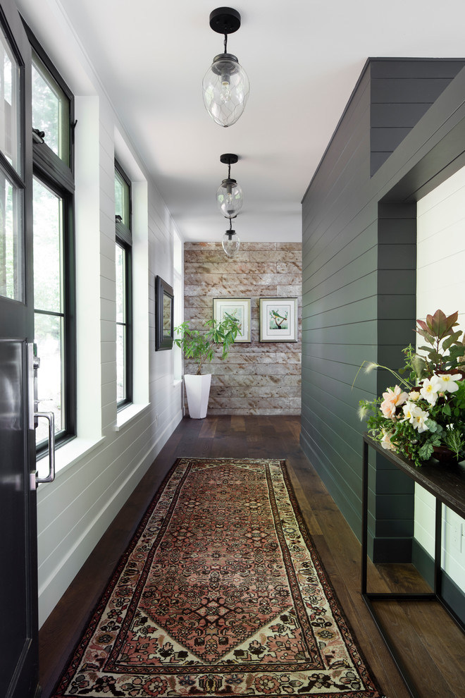 Inspiration for a large country hallway in Seattle with white walls, dark hardwood floors and brown floor.