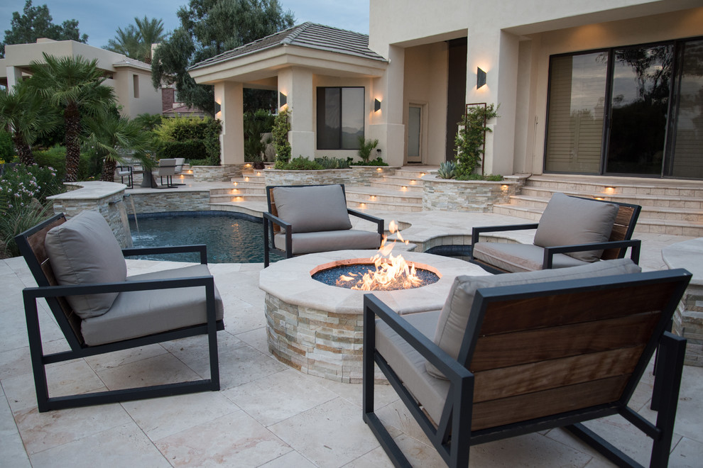 Photo of a mid-sized eclectic backyard patio in Phoenix with natural stone pavers.