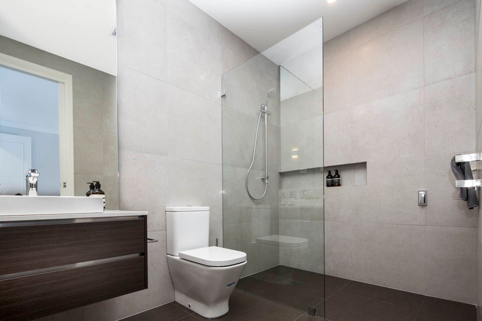 Design ideas for a mid-sized contemporary bathroom in Brisbane with a vessel sink, flat-panel cabinets, dark wood cabinets, engineered quartz benchtops, an open shower, a one-piece toilet, gray tile, porcelain tile, grey walls and porcelain floors.