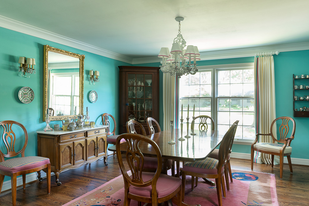 This is an example of a large traditional separate dining room in Kansas City with blue walls, dark hardwood floors and no fireplace.