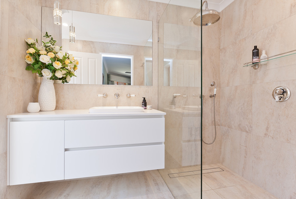 Mid-sized traditional master bathroom in Perth with furniture-like cabinets, white cabinets, a curbless shower, a one-piece toilet, beige tile, porcelain tile, beige walls, porcelain floors, a vessel sink, engineered quartz benchtops, beige floor, a hinged shower door and white benchtops.