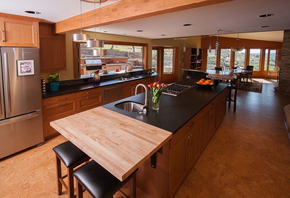 Large country u-shaped eat-in kitchen in Boise with a double-bowl sink, glass-front cabinets, light wood cabinets, soapstone benchtops, matchstick tile splashback, stainless steel appliances and multiple islands.