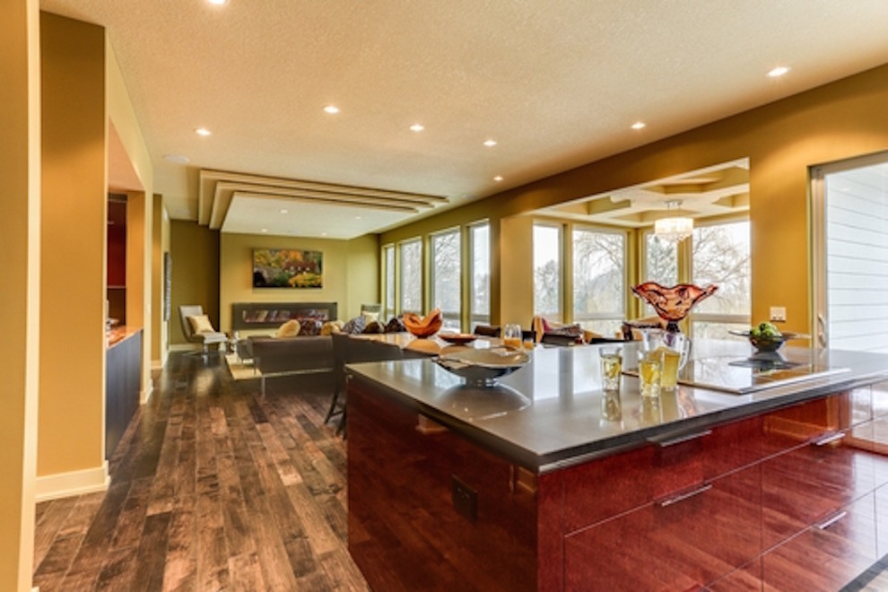 This is an example of a traditional kitchen/dining combo in Minneapolis with yellow walls and medium hardwood floors.
