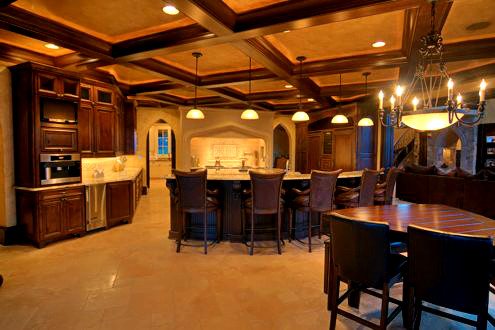 Design ideas for an expansive traditional l-shaped open plan kitchen in Charlotte with raised-panel cabinets, dark wood cabinets, beige splashback, stainless steel appliances, travertine floors and multiple islands.