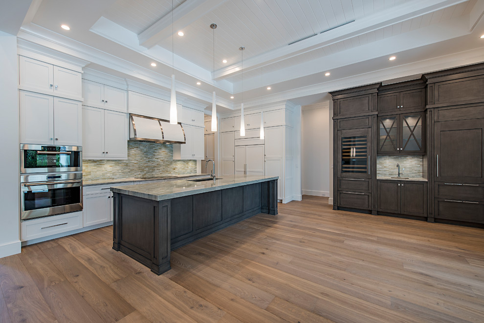 Open concept kitchen - light wood floor open concept kitchen idea with stainless steel appliances and an island